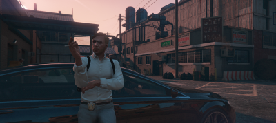 Andre Immelmann, dressed in a white shirt and light gray slacks, taking a smoke break. He is leaned against a dark-coloured Buffalo unmarked police vehicle.